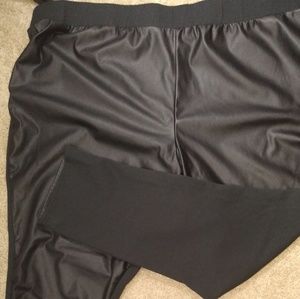 Woman within black faux leather leggings